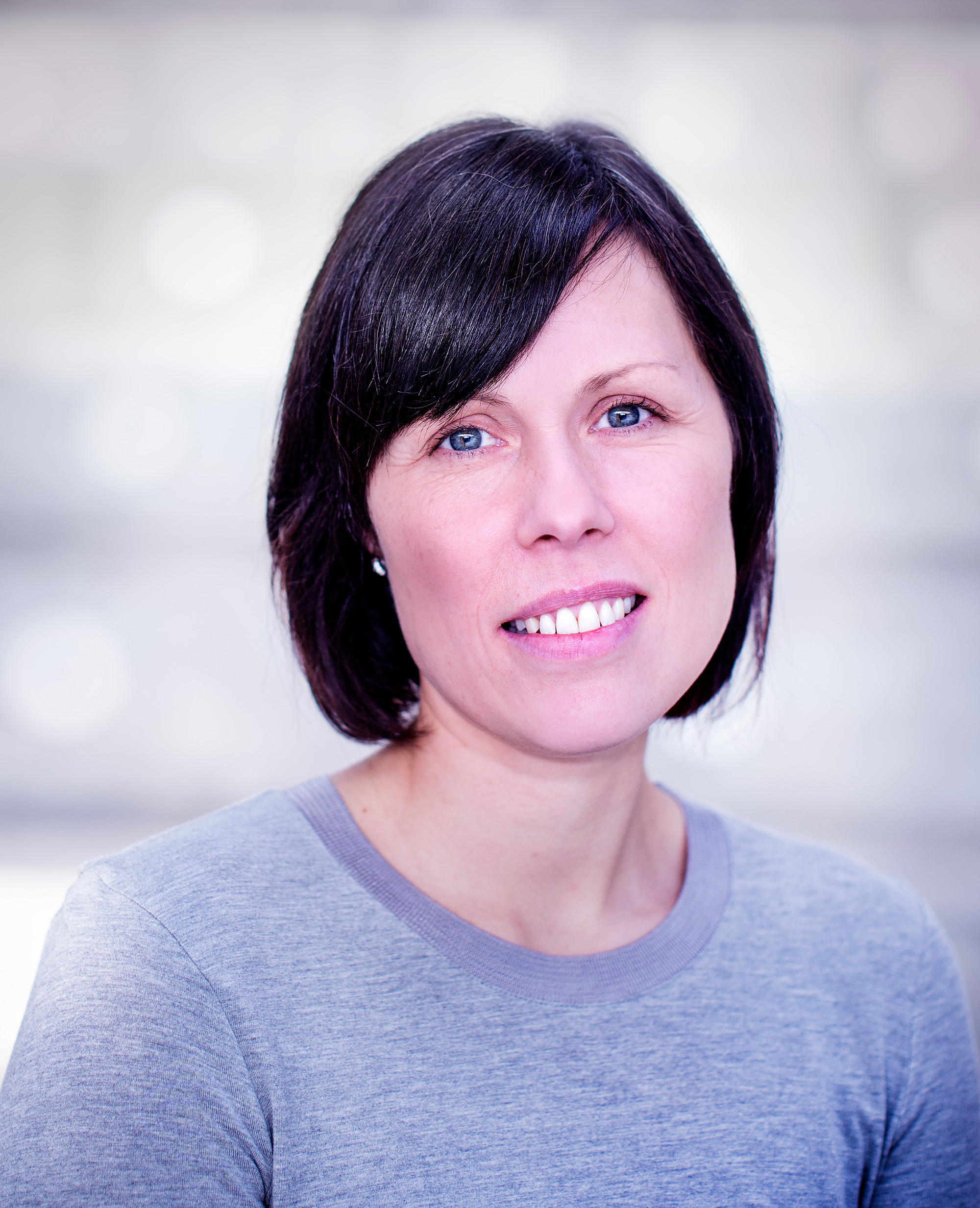 Smiling woman with blurred background.