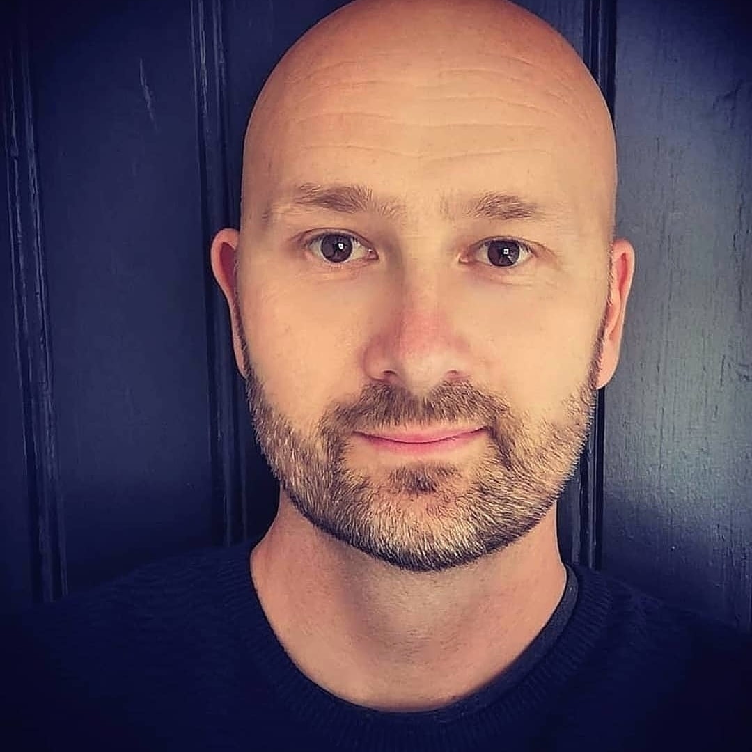 Profilbilde av mann med skjegg. Blå bakgrunn. Foto.