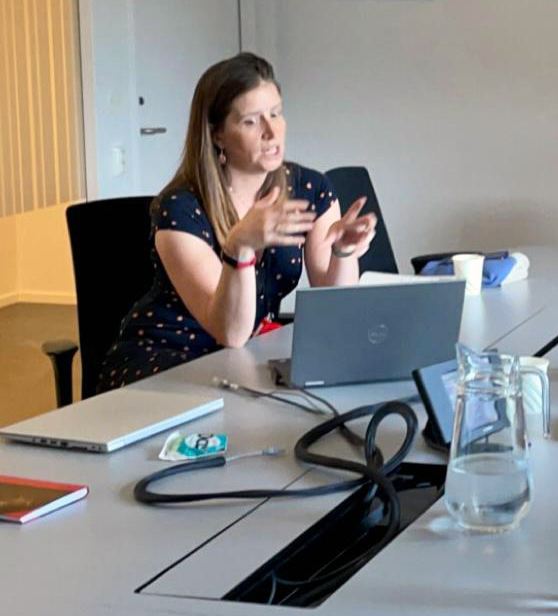 Woman talking in a meeting room.