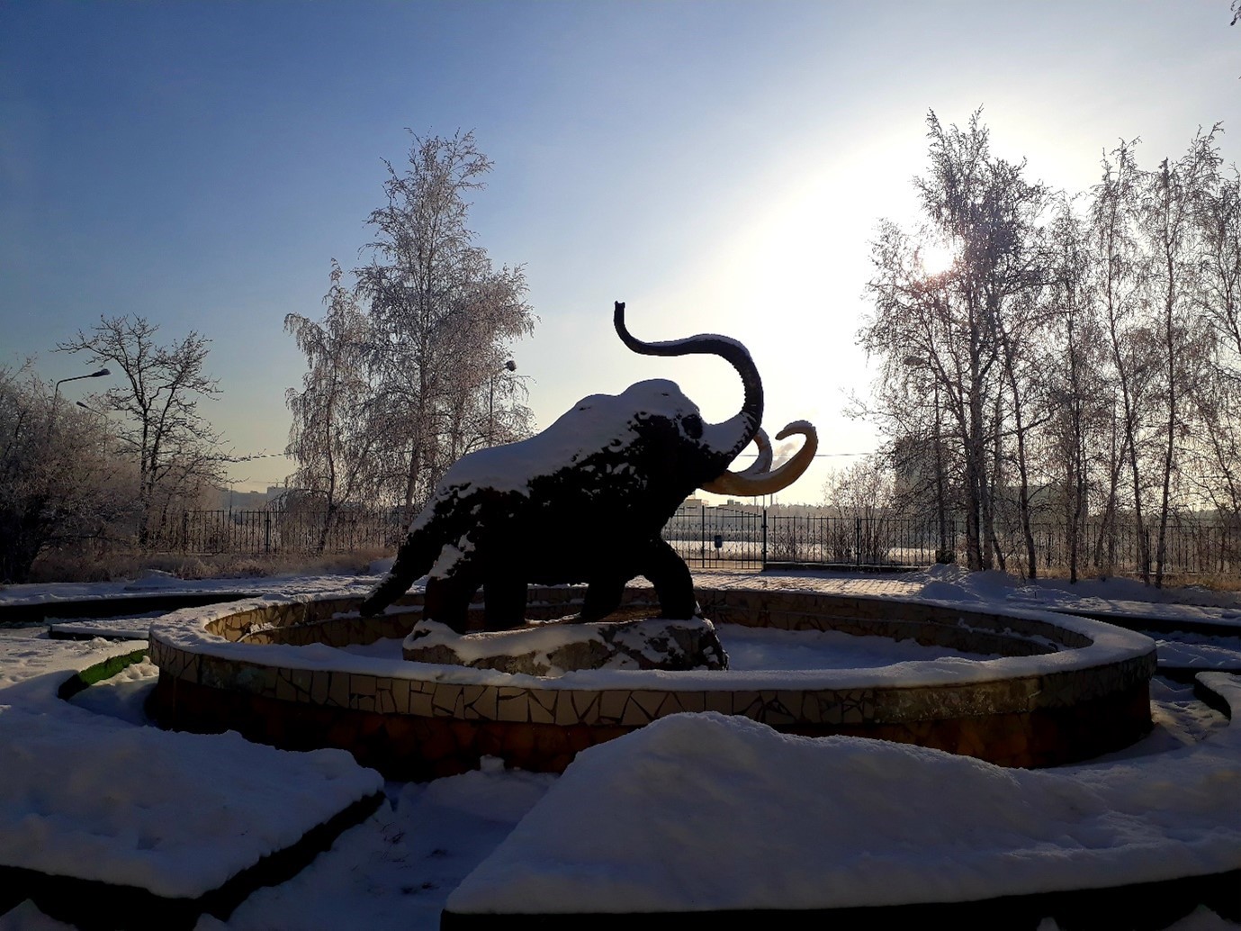 A statue of a mammoth in the snow at The Melnikov Permafrost Institute in Yakutsk, Russia