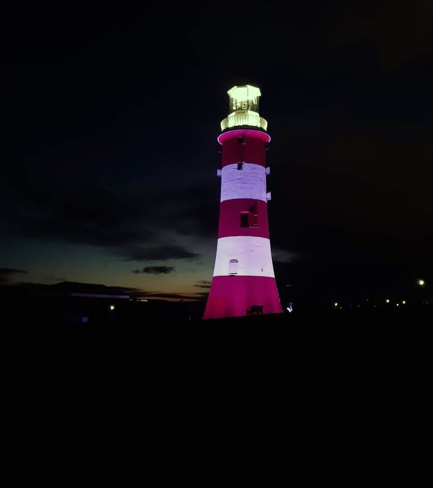The photo shows a lighthouse in Plymouth and was taken in the evening.