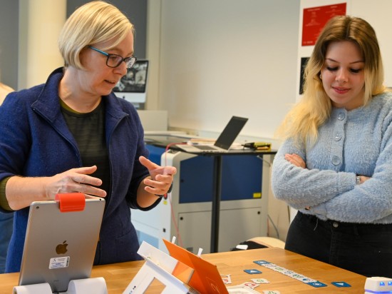 To kvinner studerer digitale leketøy som kan brukes i barnehage