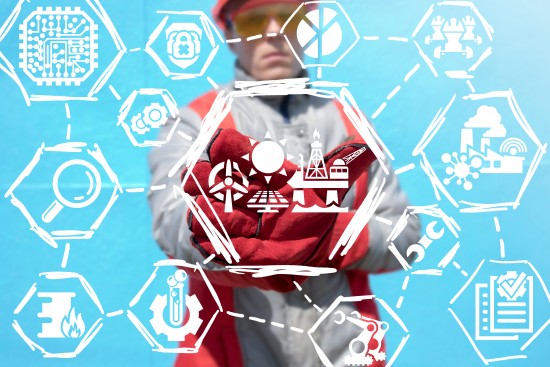 Industrial worker offers a wind station with solar system and sea offshore oil platform icon on a virtual panel. Modern energy production concept. Smart power plant technology. Photo: Shutterstock
