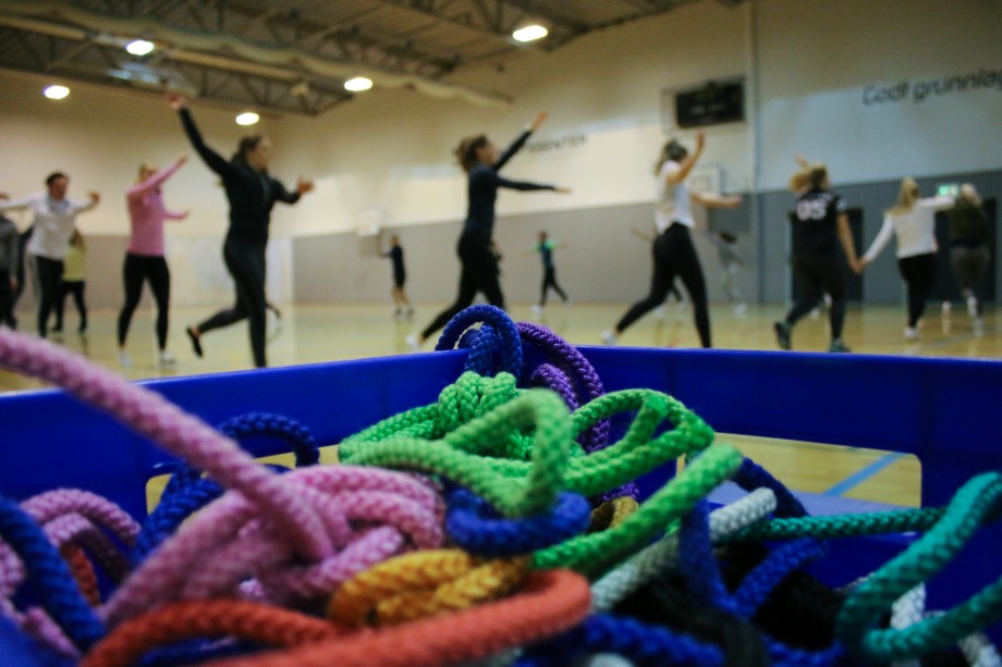 Idrettsstudenter løper i gymsal