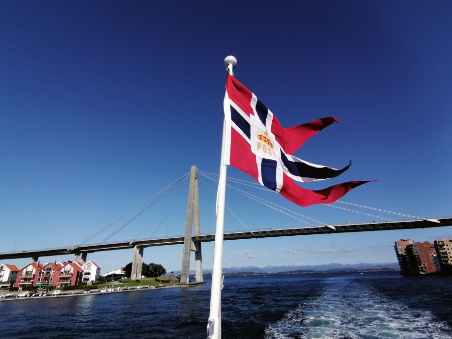 A flag in front of the ocean outside Stavanger.