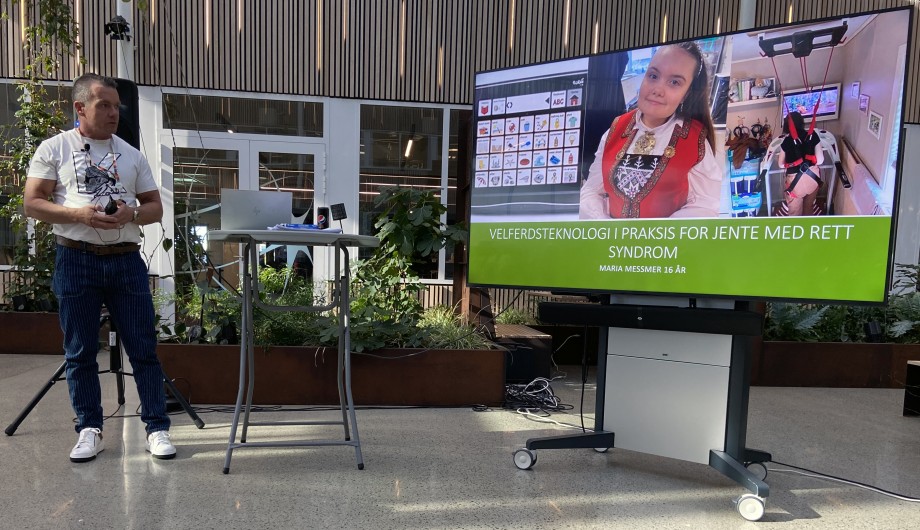 Man looking towards the screen where his presentation is.