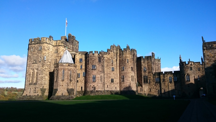 A castle seen in silhouette against a blue sky