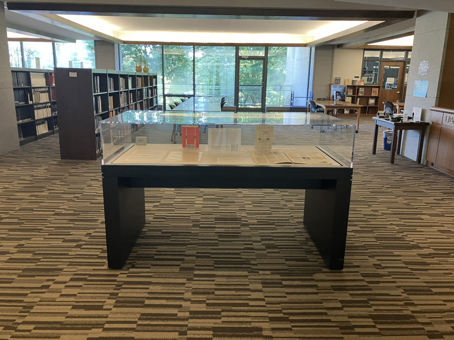 A glass case with books on display in the entrance to a library
