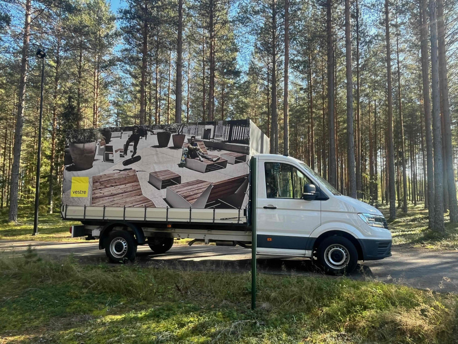 A white furniture van in the forest