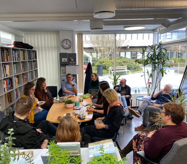 Members of The Greenhouse meet in the Greenhouse library