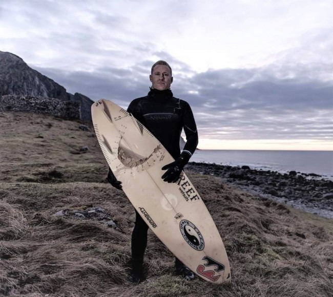 Shannon Ainslie holding a surfboard